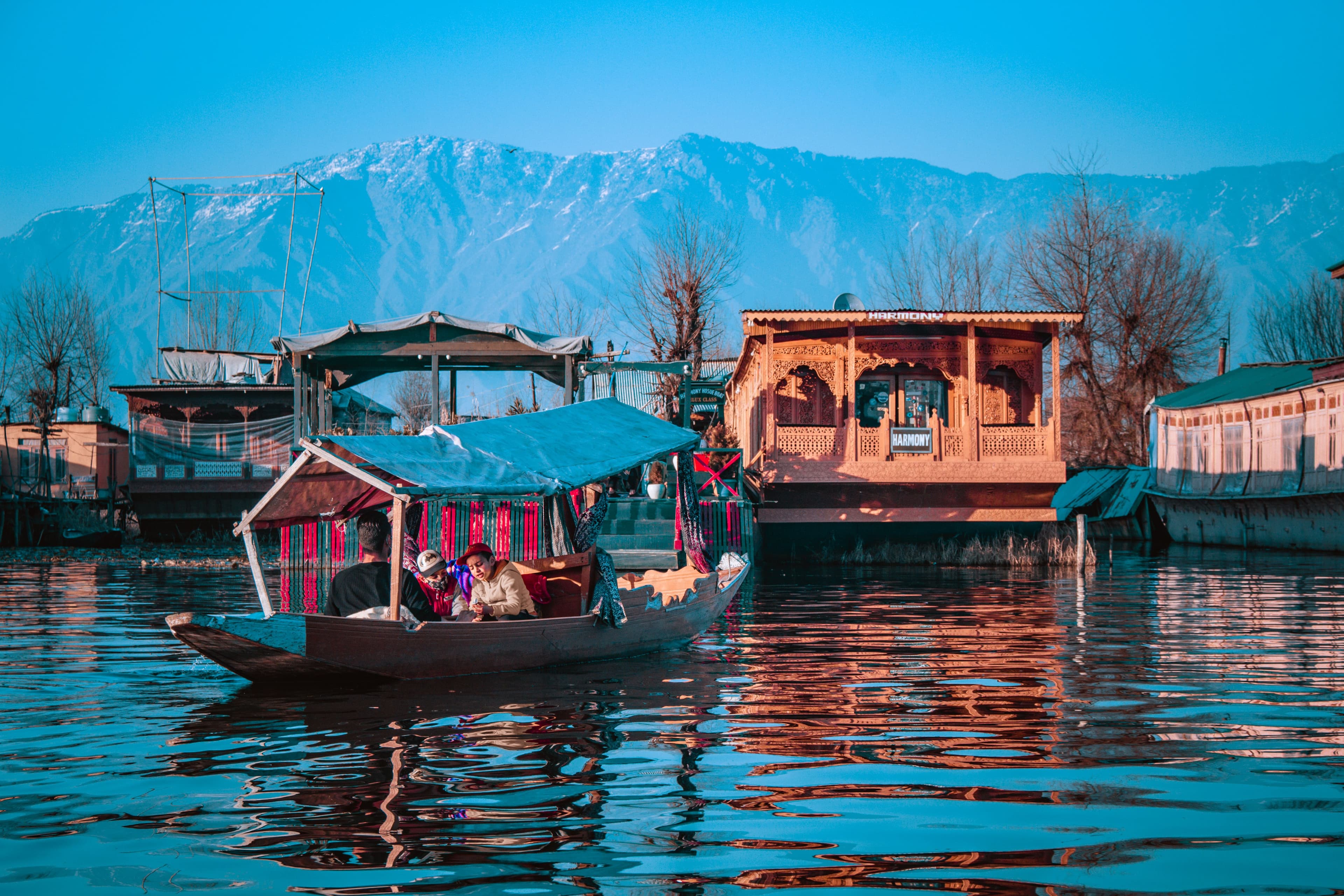 Luxury Kashmir houseboat experience on Dal Lake surrounded by Himalayan mountains